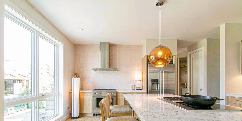 Amber glass globe pendant over a kitchen island Amber glass globe pendant over a kitchen island